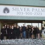 The expert team at the best salon and spa in Littleton, CO—Silver Palm Salon & Spa—outside the salon entrance.