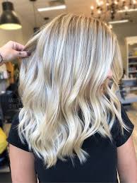 Blonde hair with soft waves and dimensional highlights, showcasing a modern hairstyle from Silver Palm Salon, emphasizing luxury hair color techniques.
