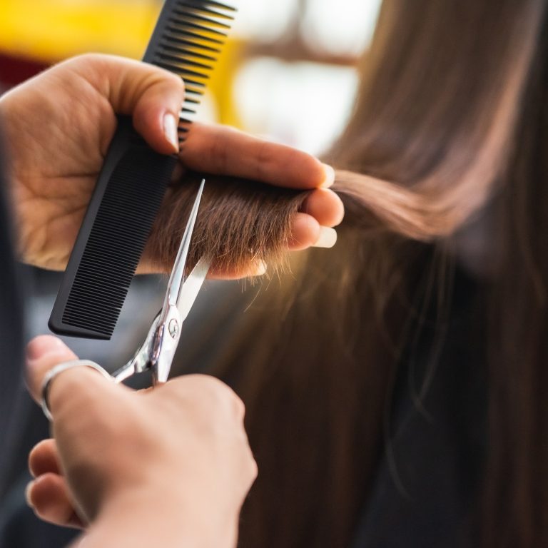 Salon Littleton stylist performing a precision haircut at Silver Palm